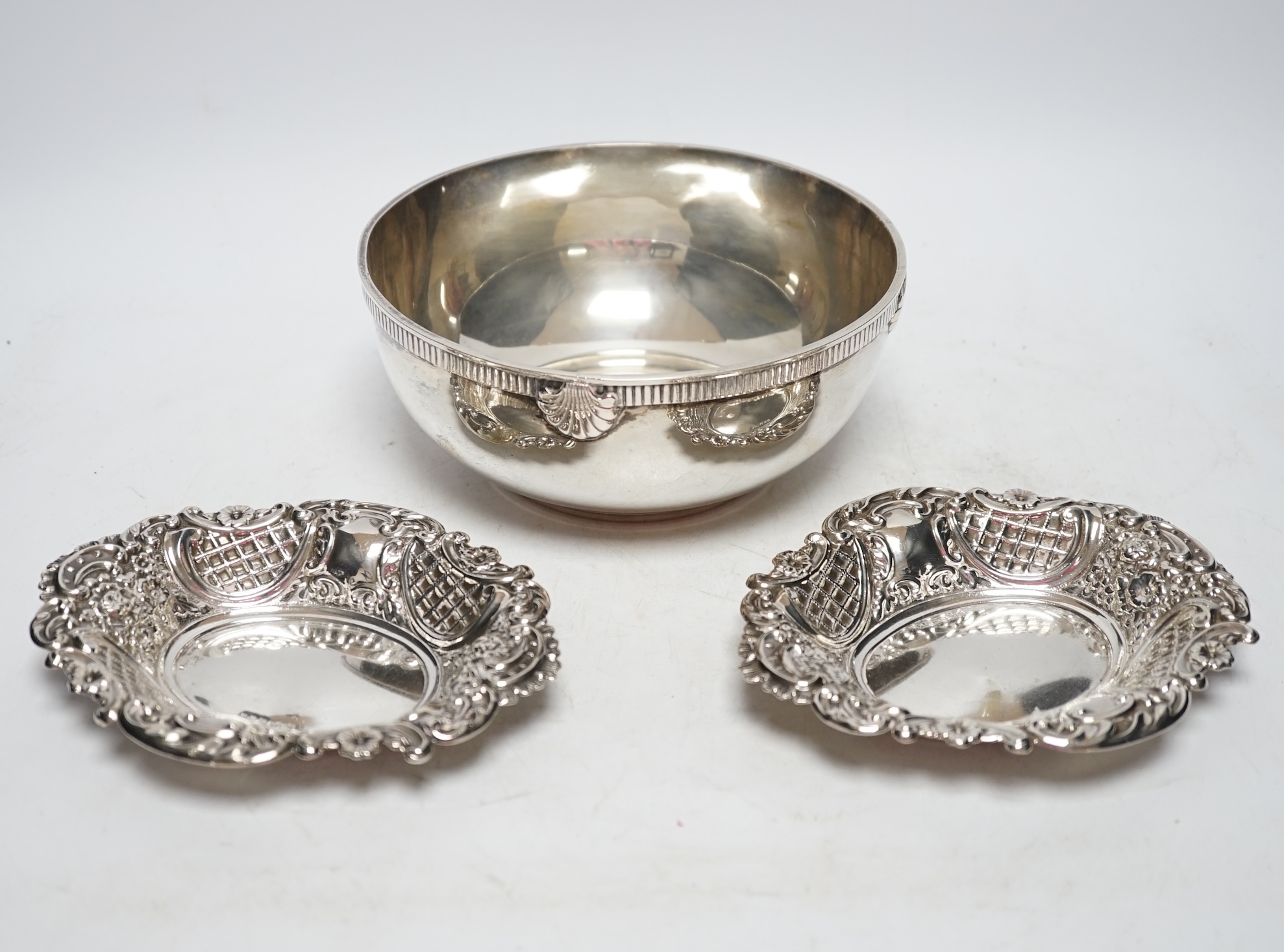 An 800 standard white metal bowl, diameter 17.3cm and a pair of George V pierced silver bonbon dishes, 18.7oz. Fair condition.